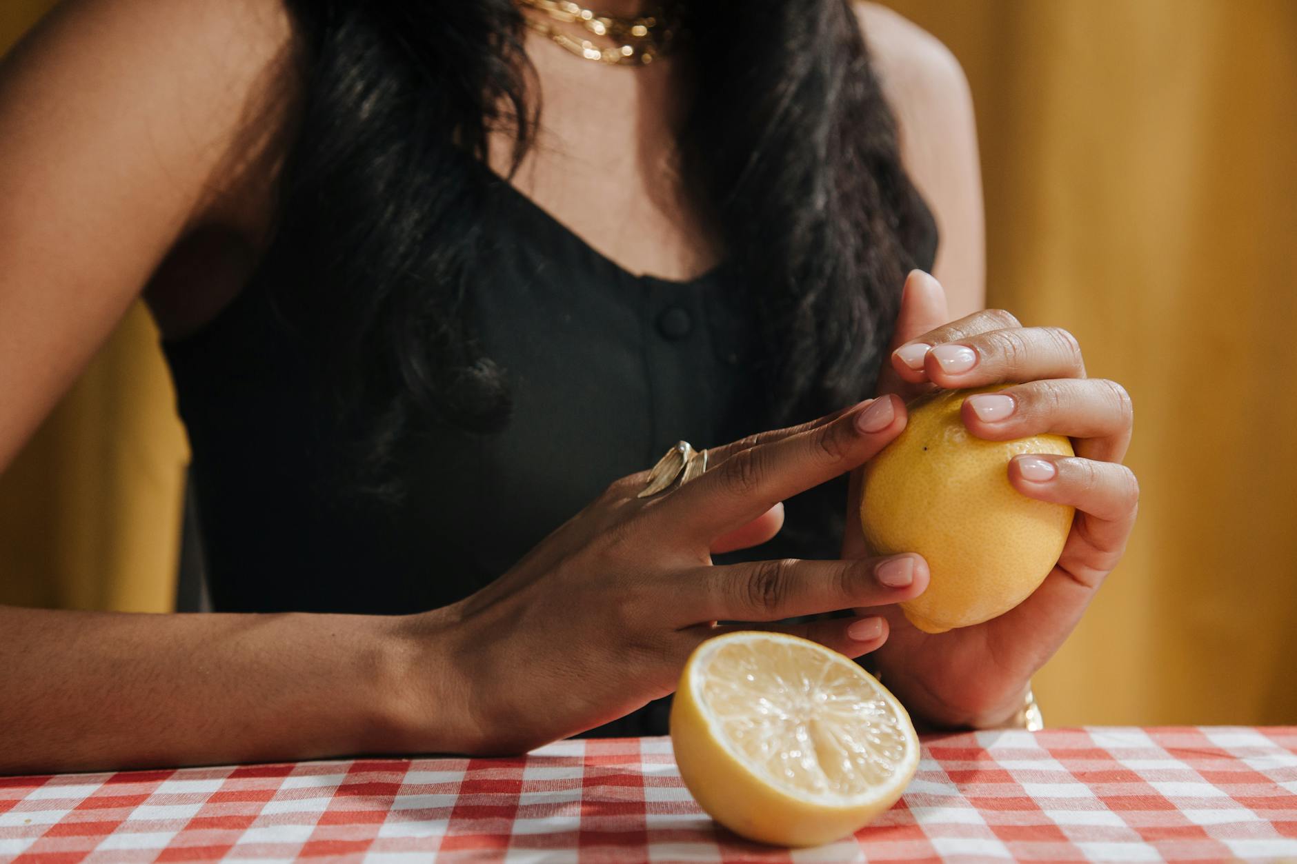A hand holding a vibrator above a decorative glass bowl, representing accessible intimate wellness for couples.